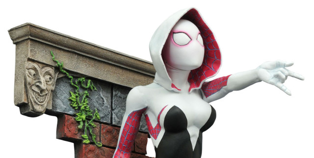 Marvel Gallery Spider-Gwen Figure with Green Goblin Head on Brick Wall