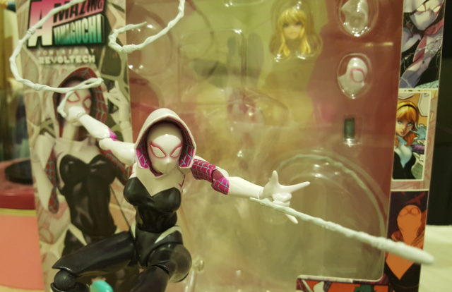 Kaiyodo Revoltech Spider-Gwen Figure Swinging In Front of Box